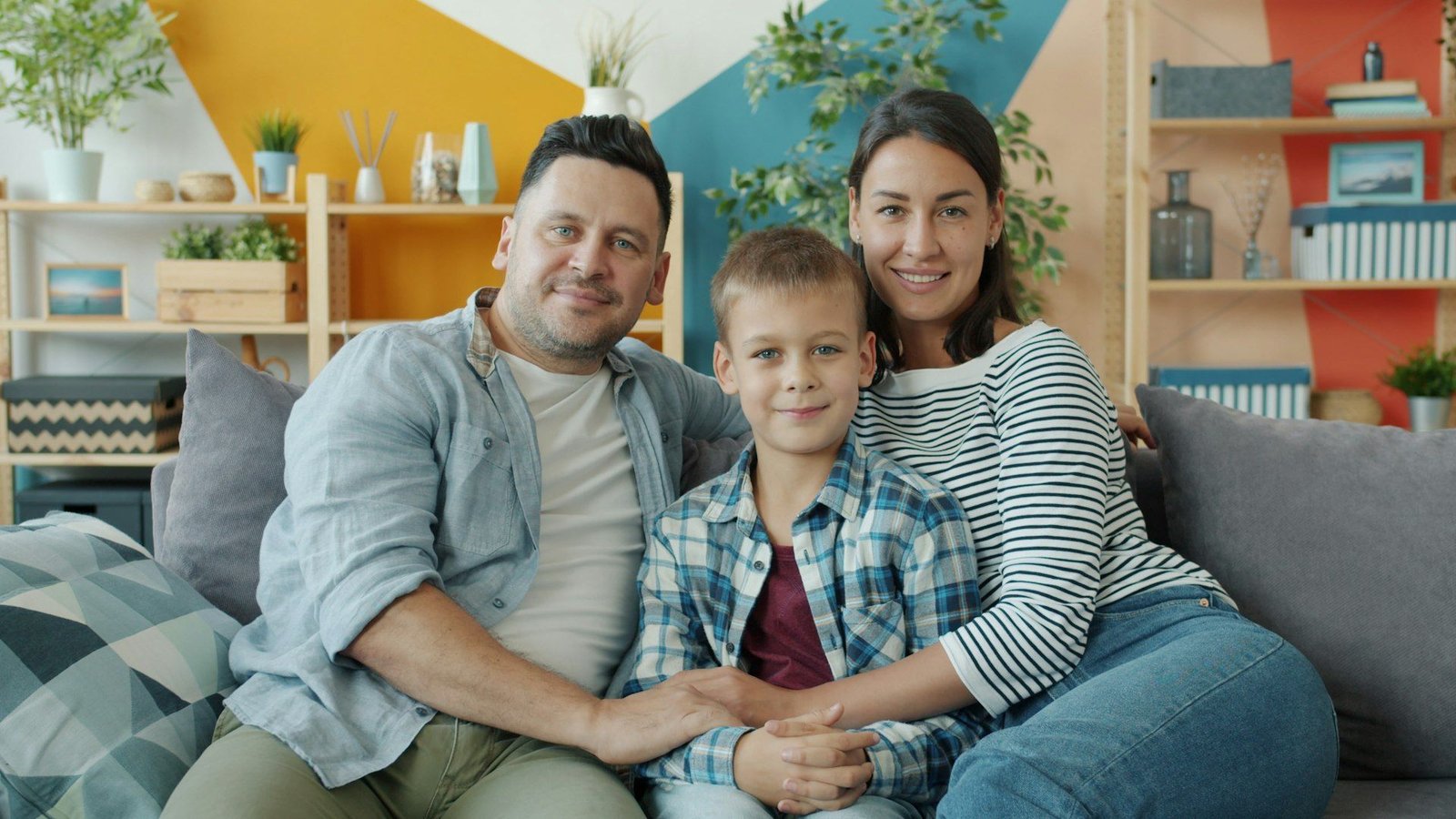 A young family together on the sofa of a modern home